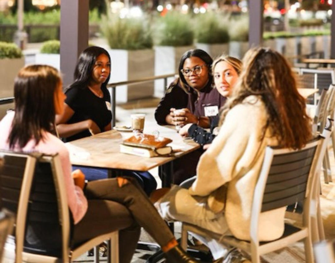 Friends gathering around a table