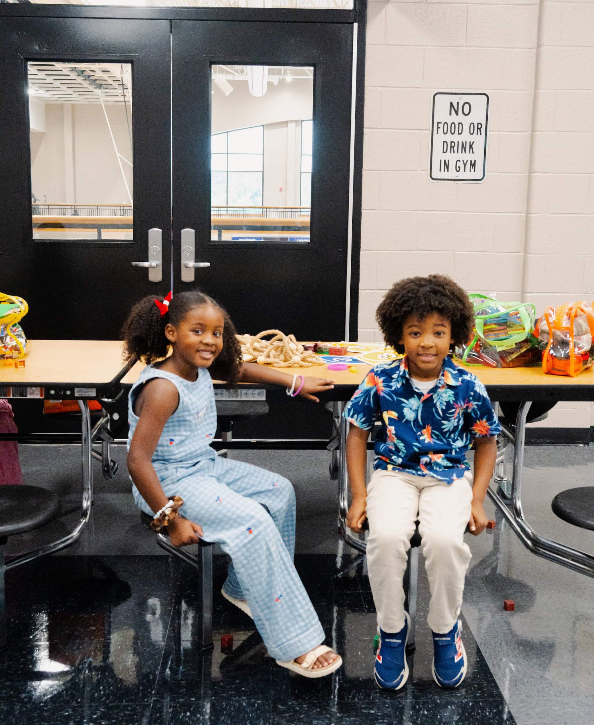Two children seated in a LIIV Kids classroom
