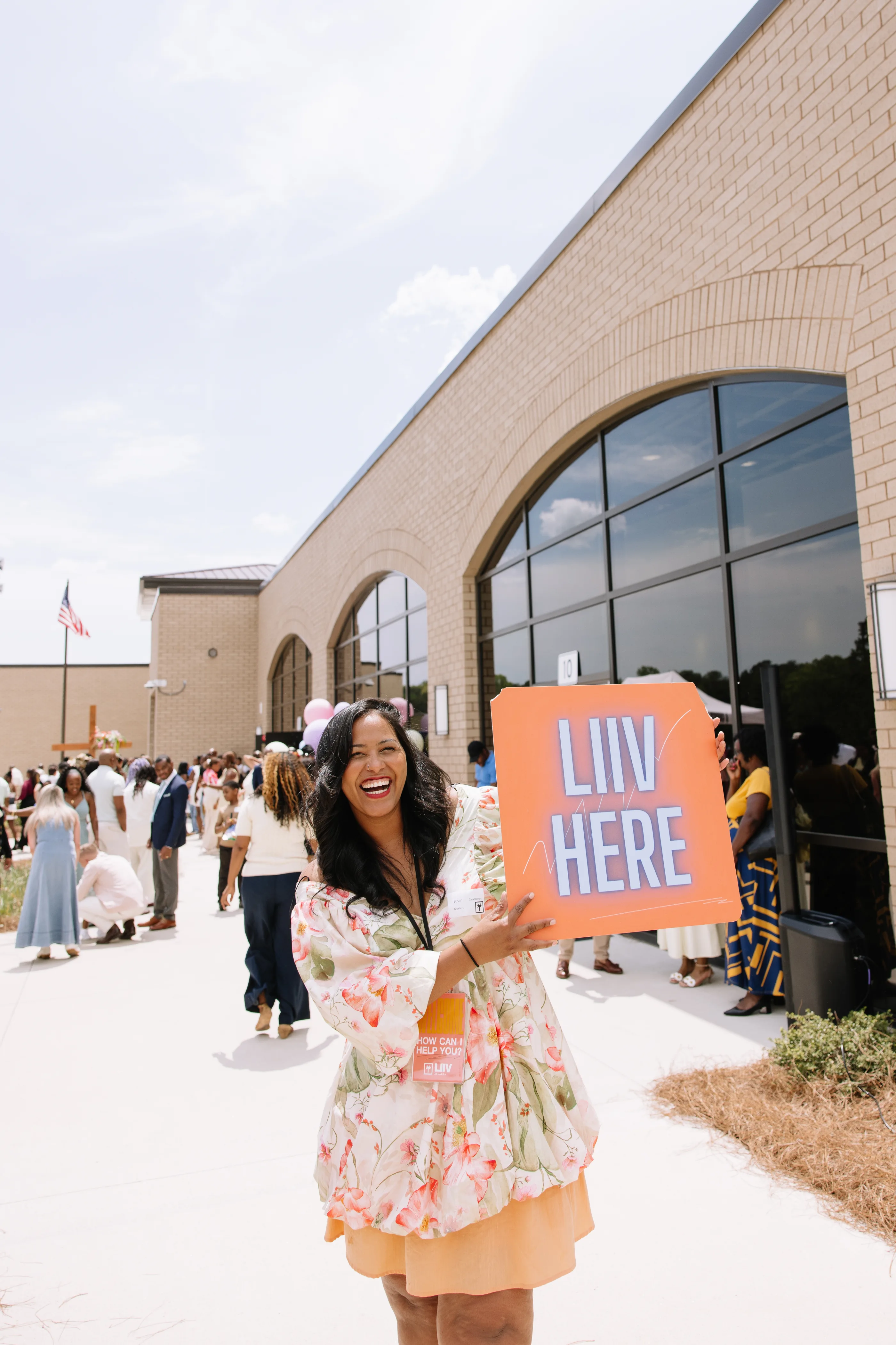 A smiling LIIV team member welcoming people to church