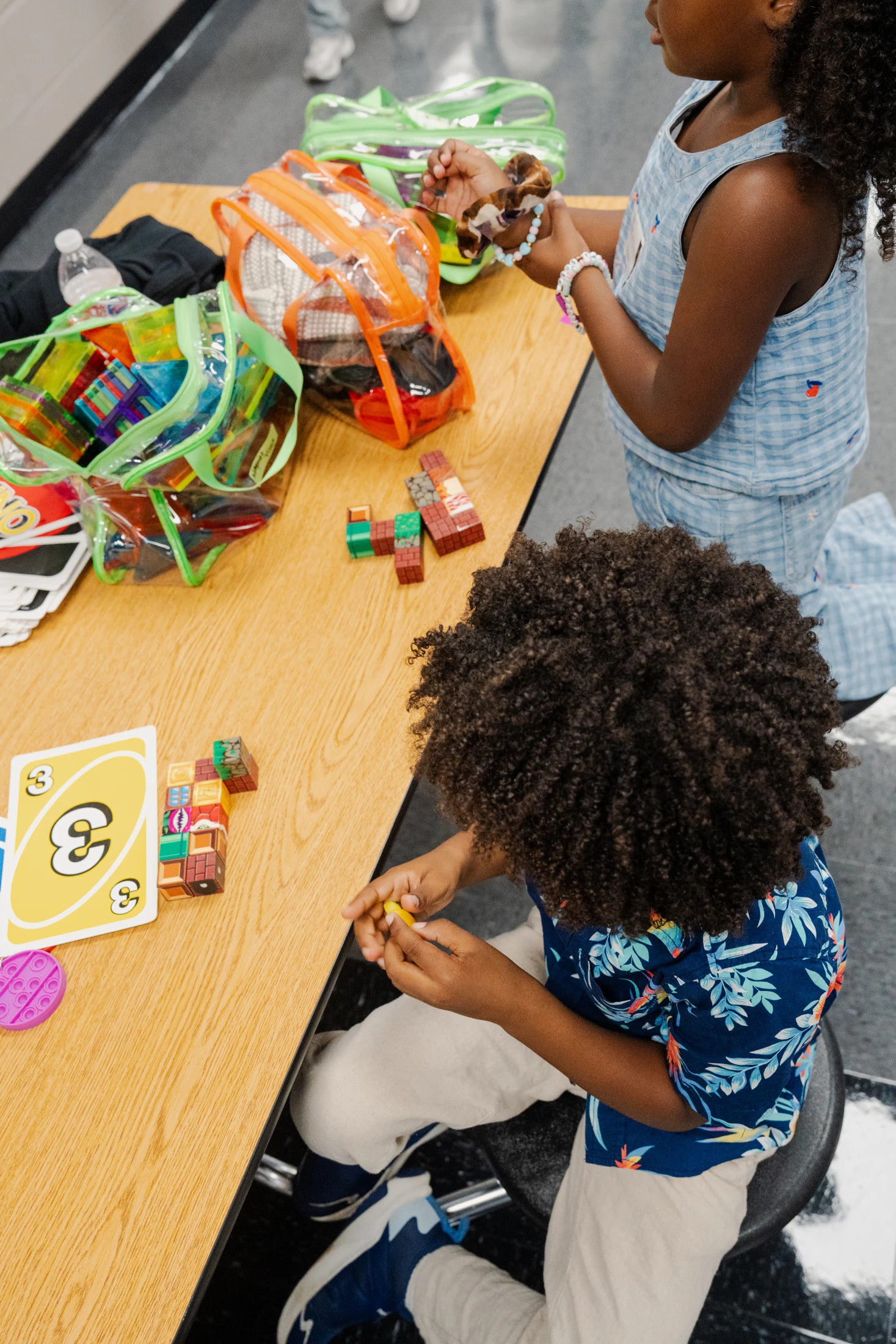 Children playing with toys and activity bags at LIIV Kids